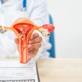 A female doctor sits at a desk in hospital explains about uterine conditions such as endometriosis